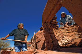 Nadine Chapito shovels mud to her partner Adrian as they work on restoring the ovens of Fernandez Lementino in Zuni on Friday. © 2011 Gallup Independent / Adron Gardner 